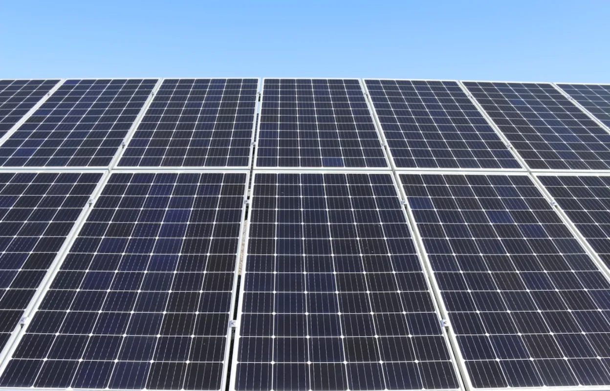Technicians installing solar panels on a roof